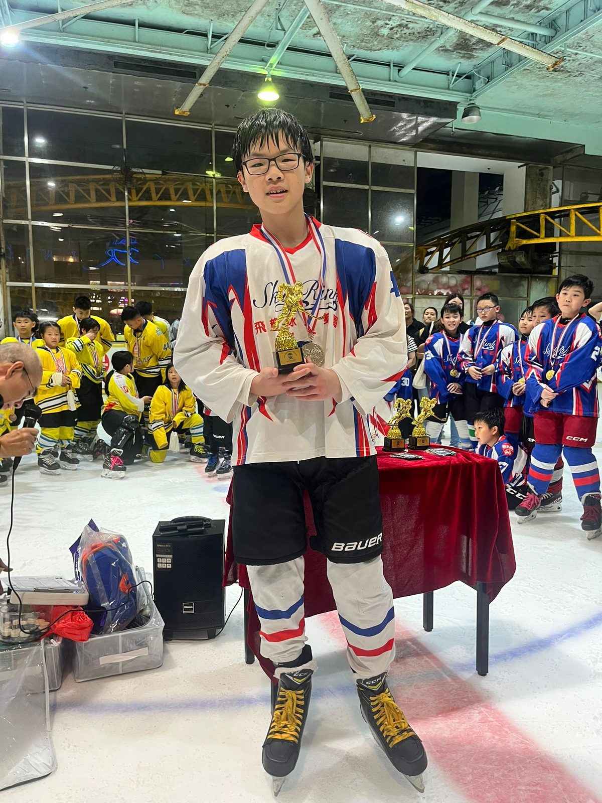 Young player in the club jersey with his medal and trophy
