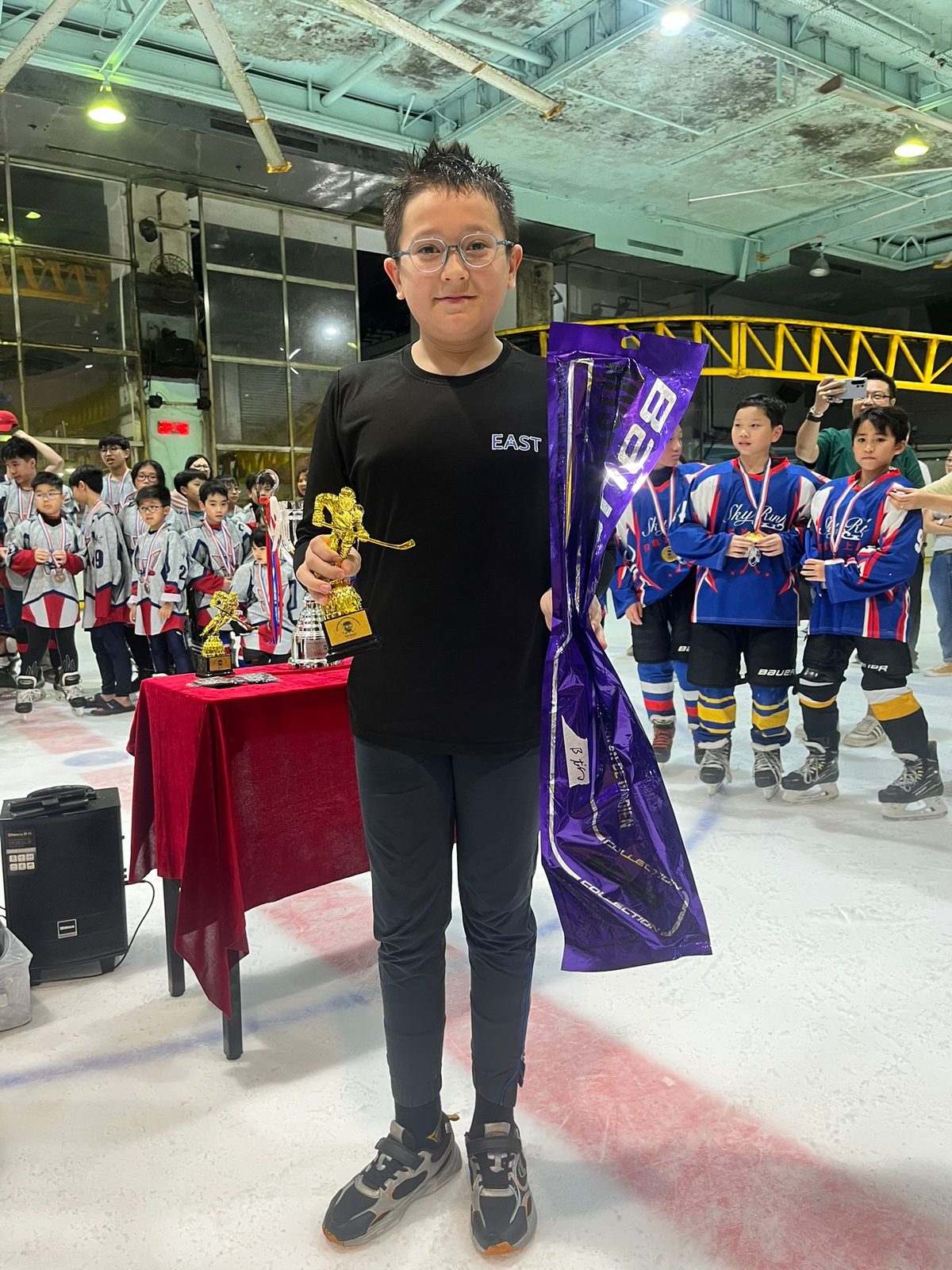 Young player holding up her prize at the awards ceremony