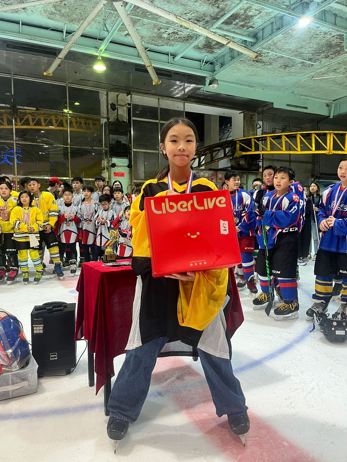 Player collecting a prize with all the teams lined up behind