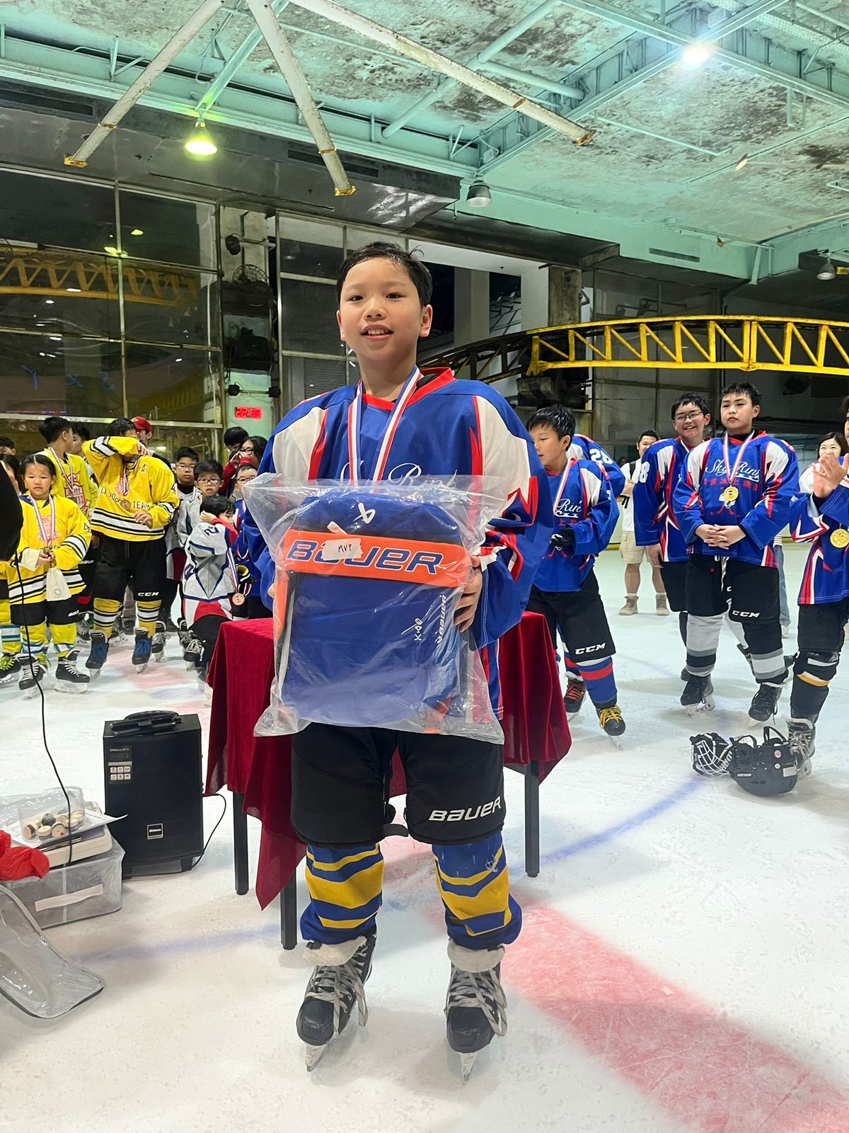 Player showing off his prize bag on the ice