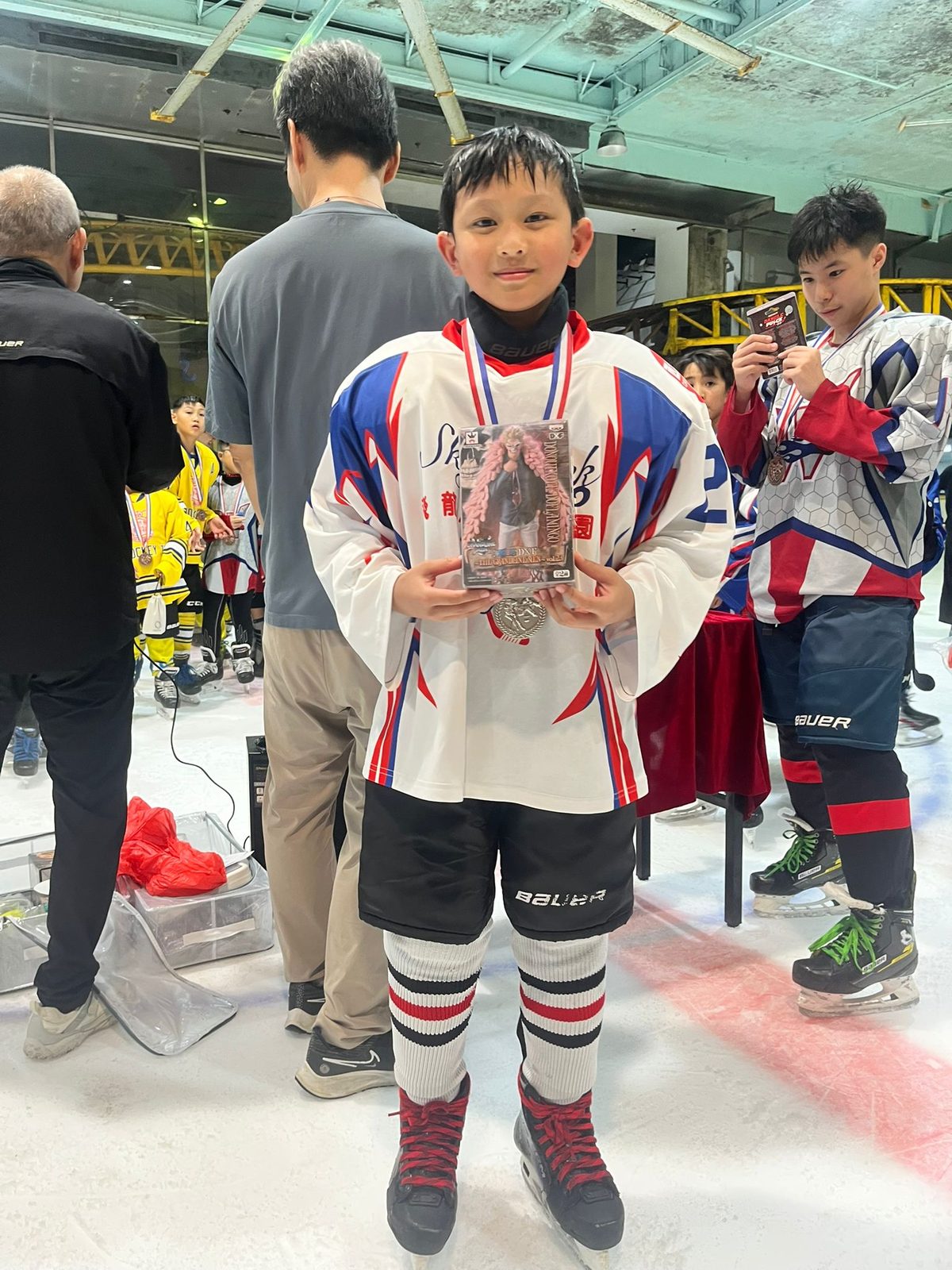 Player holding his prize on the blue line