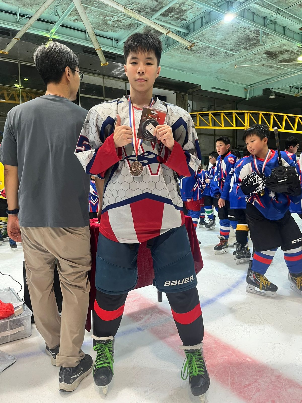 Player receiving his medal with the teams looking on