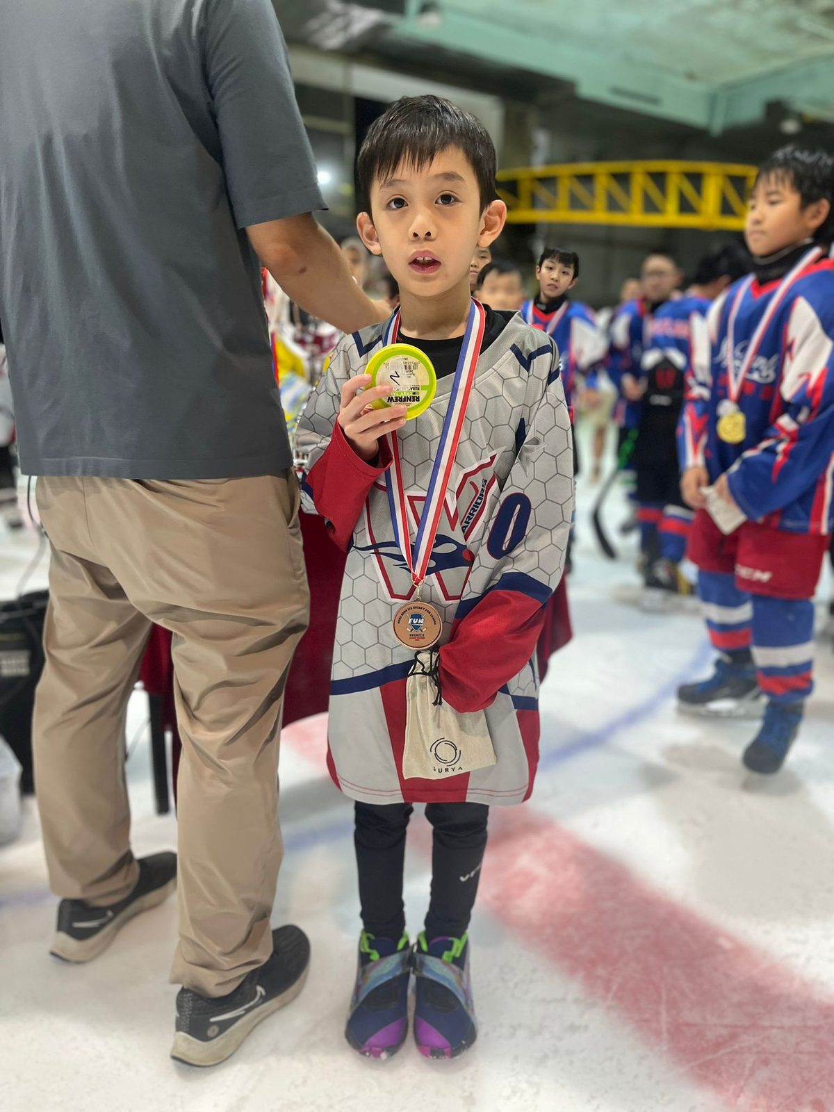 One of the youngest players showing off his medal