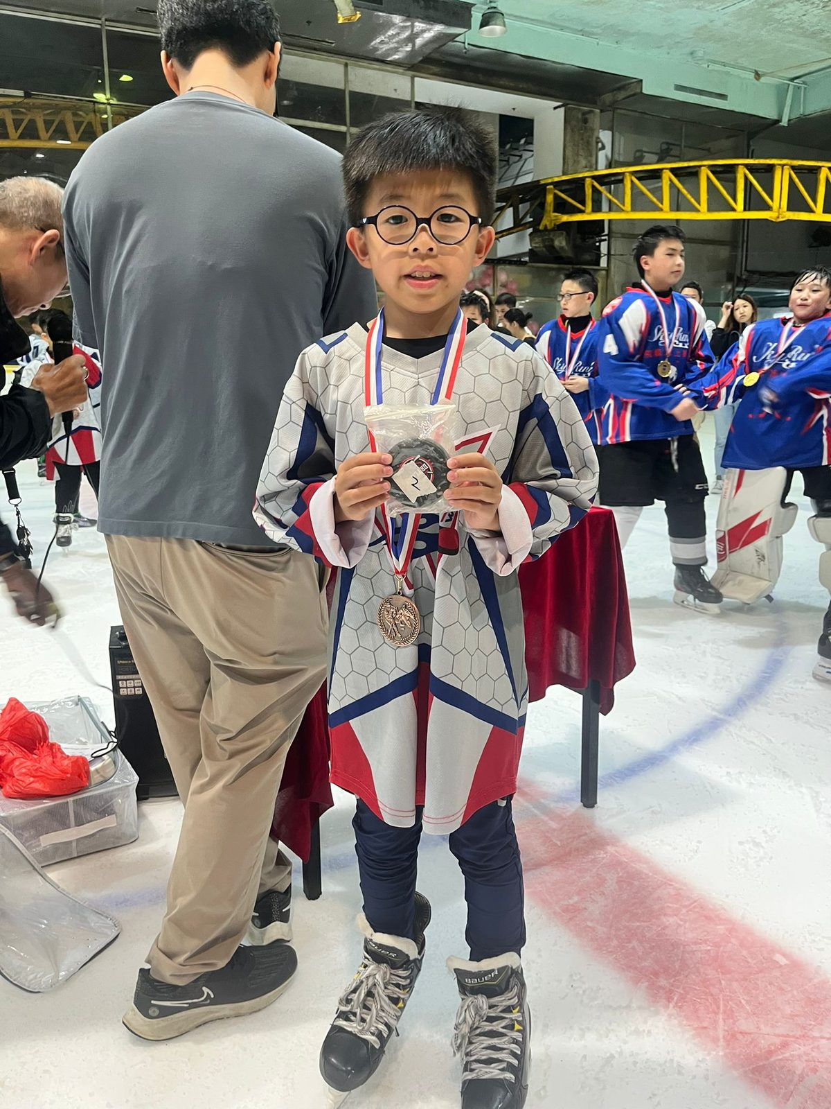 Player with his medal and prize at centre ice